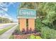 The Caravelle Resort Hotel sign, showcasing local businesses, enhanced by lush landscaping at 6900 N Ocean Blvd. # 1135, Myrtle Beach, SC 29572