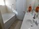 Bright bathroom with double sinks, soaking tub, neutral tile, and ample counter space at 741 Londonberry Ct., Conway, SC 29526