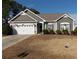 Beautiful one-story home with fresh landscaping, neutral siding, brick detail, and attached garage at 741 Londonberry Ct., Conway, SC 29526