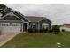 Charming single-story home with gray siding, well-maintained landscaping, and attached two-car garage at 741 Londonberry Ct., Conway, SC 29526