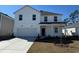 Charming two-story home featuring a clean white exterior, attached garage, and a well-manicured front yard at 977 Laconic Dr., Myrtle Beach, SC 29588