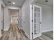 Gray walls and wood-look floors in this bright hallway at 1310 Crested Iris Way, North Myrtle Beach, SC 29582