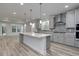 Modern kitchen with gray cabinets, quartz counters, and island at 1310 Crested Iris Way, North Myrtle Beach, SC 29582