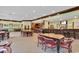 Open dining area with tables, chairs, and a fully equipped bar, perfect for socializing and enjoying refreshments at 1514 Clubstone Dr., Conway, SC 29526