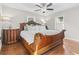 This bedroom features a wooden bed frame, a ceiling fan, and hardwood floors at 1673 Middleton St., Georgetown, SC 29440