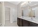 Well-lit bathroom featuring double sink vanity with dark cabinets and a large mirror at 1711 Sapphire Dr., Longs, SC 29568