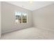 Neutral bedroom featuring a large window overlooking an outside view at 1711 Sapphire Dr., Longs, SC 29568