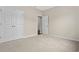 Cozy bedroom featuring neutral carpeting, closet with bi-fold doors, and an ensuite bath at 1711 Sapphire Dr., Longs, SC 29568