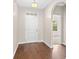Inviting foyer featuring hardwood floors, a white front door, and ample natural light creating a bright entry space at 1711 Sapphire Dr., Longs, SC 29568