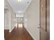 Long hallway with hardwood floors, archways, and neutral paint, creating a welcoming and spacious entrance into the home at 1711 Sapphire Dr., Longs, SC 29568