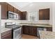 Kitchen featuring granite countertops, stainless steel appliances, and dark wood cabinets at 1711 Sapphire Dr., Longs, SC 29568