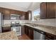 Kitchen with granite countertops, stainless steel appliances, and dark wood cabinets at 1711 Sapphire Dr., Longs, SC 29568