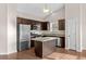 Modern kitchen featuring stainless steel appliances, granite countertops, dark cabinets, and natural light at 1711 Sapphire Dr., Longs, SC 29568