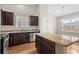 Kitchen showcases granite countertops, stainless steel appliances, dark cabinets, and wood flooring at 1711 Sapphire Dr., Longs, SC 29568