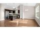 Open kitchen featuring dark cabinets, stainless steel appliances, granite countertops, and an island at 1711 Sapphire Dr., Longs, SC 29568