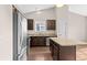 Modern kitchen features stainless steel appliances, dark cabinets, granite countertops, and wood flooring at 1711 Sapphire Dr., Longs, SC 29568