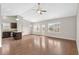 Bright, open space featuring hardwood floors, vaulted ceilings, a ceiling fan, and a view of the fenced-in backyard at 1711 Sapphire Dr., Longs, SC 29568