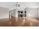 Open-concept living room featuring hardwood floors, neutral paint, vaulted ceilings and a seamlessly adjoining kitchen at 1711 Sapphire Dr., Longs, SC 29568