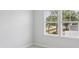 Bedroom with large windows providing natural light and views of the tree-lined neighborhood at 2400 Hillbourne Loop, North Myrtle Beach, SC 29582