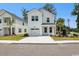 Charming two-story white home featuring a one-car garage and well-manicured lawn at 2400 Hillbourne Loop, North Myrtle Beach, SC 29582