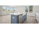 Kitchen island with quartz countertop, stainless steel dishwasher and sink, and scenic backyard views at 2620 Hillbourne Loop, North Myrtle Beach, SC 29582