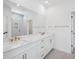 Elegant bathroom with double sinks, white cabinetry, quartz countertop, and a glass-enclosed shower at 2624 Hillbourne Loop, North Myrtle Beach, SC 29582