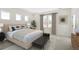 Serene bedroom with neutral tones, a large bed, and ample natural light from three windows at 2624 Hillbourne Loop, North Myrtle Beach, SC 29582