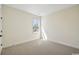 Bright bedroom features a cozy carpet, neutral walls, and a sun-filled window at 2624 Hillbourne Loop, North Myrtle Beach, SC 29582