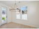 Bright dining area features a stylish chandelier and ample natural light from the surrounding windows at 2624 Hillbourne Loop, North Myrtle Beach, SC 29582