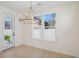 Bright dining room with a modern chandelier, large windows, and access to an outdoor space at 2624 Hillbourne Loop, North Myrtle Beach, SC 29582