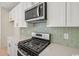 A modern stainless steel range and hood with a green backsplash are showcased at 2624 Hillbourne Loop, North Myrtle Beach, SC 29582