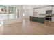 Bright, open-concept living area features hardwood floors, ample natural light, and a modern kitchen island at 2624 Hillbourne Loop, North Myrtle Beach, SC 29582