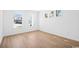 Spacious bedroom with hardwood flooring, white walls, and natural light from three windows at 2628 Hillbourne Loop, North Myrtle Beach, SC 29582