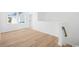 Upstairs landing with wood flooring, white walls, and bright natural light from two windows at 2628 Hillbourne Loop, North Myrtle Beach, SC 29582