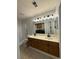 Bathroom with double vanity, large mirror, and view into laundry room at 3517 Crepe Myrtle Ct. # 3517, Myrtle Beach, SC 29577