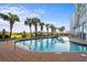 Resort-style pool with palm trees and lounge chairs at 6804 N Ocean Blvd. # 723, Myrtle Beach, SC 29572