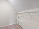 A spare attic room with a neutral carpet, closet, and shelf for extra storage space at 765 Ashley Manor Dr., Longs, SC 29568