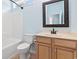 Well-lit full bath features a shower-tub combo and vanity with wood cabinets at 765 Ashley Manor Dr., Longs, SC 29568