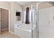 This bright bathroom features a soaking tub, stand up shower, and window for natural light at 765 Ashley Manor Dr., Longs, SC 29568