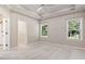 Spacious bedroom with tray ceiling, carpet, and two windows bringing natural light at 765 Ashley Manor Dr., Longs, SC 29568