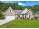 Charming brick home with a well-manicured lawn, attached garage, and inviting front entrance at 765 Ashley Manor Dr., Longs, SC 29568