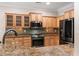 A well-lit kitchen featuring wooden cabinets, granite countertops, and stainless steel appliances at 765 Ashley Manor Dr., Longs, SC 29568