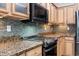 Granite countertops and a decorative backsplash highlight the gourmet kitchen at 765 Ashley Manor Dr., Longs, SC 29568