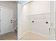 A practical laundry room has tile flooring, white walls and doors and utility connections at 765 Ashley Manor Dr., Longs, SC 29568