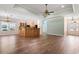 An open floor plan with light wood cabinets and floors with a tray ceiling above at 765 Ashley Manor Dr., Longs, SC 29568