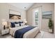 Beautifully staged main bedroom is decorated in soft neutral tones with a window letting in plenty of natural light at 765 Ashley Manor Dr., Longs, SC 29568