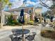Outdoor patio area features umbrella-covered tables near a charming two-story building at 765 Ashley Manor Dr., Longs, SC 29568