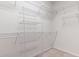 A walk-in closet features white wire shelving for organizing clothes and accessories at 765 Ashley Manor Dr., Longs, SC 29568