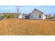Expansive backyard featuring a well-maintained lawn and views of the home's exterior at 1139 Parish Way, Myrtle Beach, SC 29577