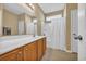 Bright bathroom featuring a shower-tub combination with a white shower curtain and a spacious vanity with a large mirror at 1139 Parish Way, Myrtle Beach, SC 29577